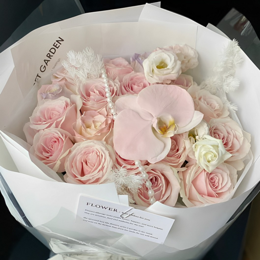 Pink roses mixed with pink Phalaenopsis  bouquet